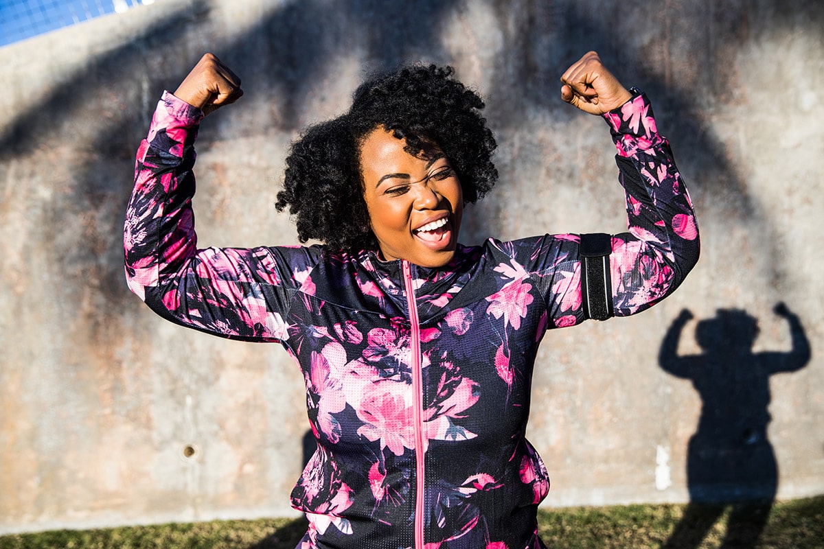 Happy woman with arms up