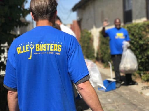 Man with back turned wearing AlleyBusters shirt
