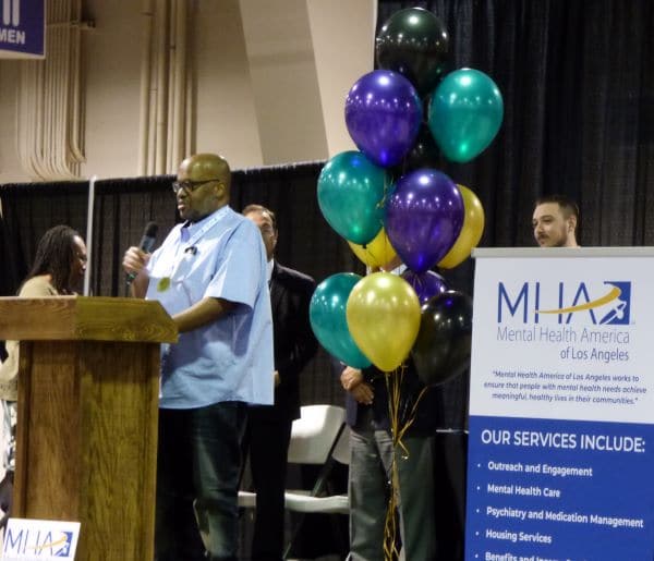 Man winning award, at podium