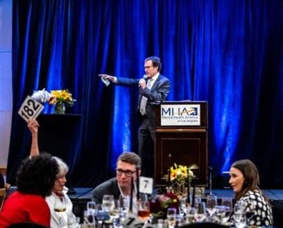 Auctioneer at event pointing at someone
