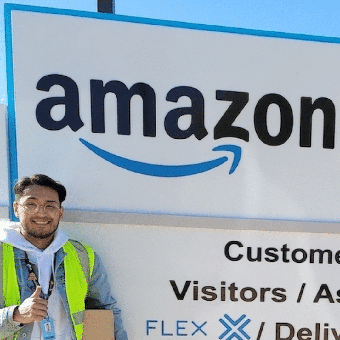 A man in front of Amazon sign