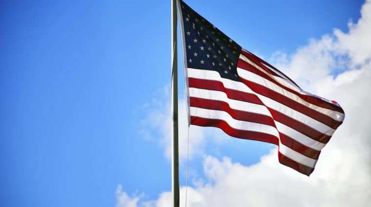 American flag with sky behind it
