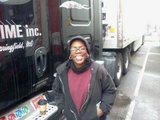 smiling woman in front of a truck