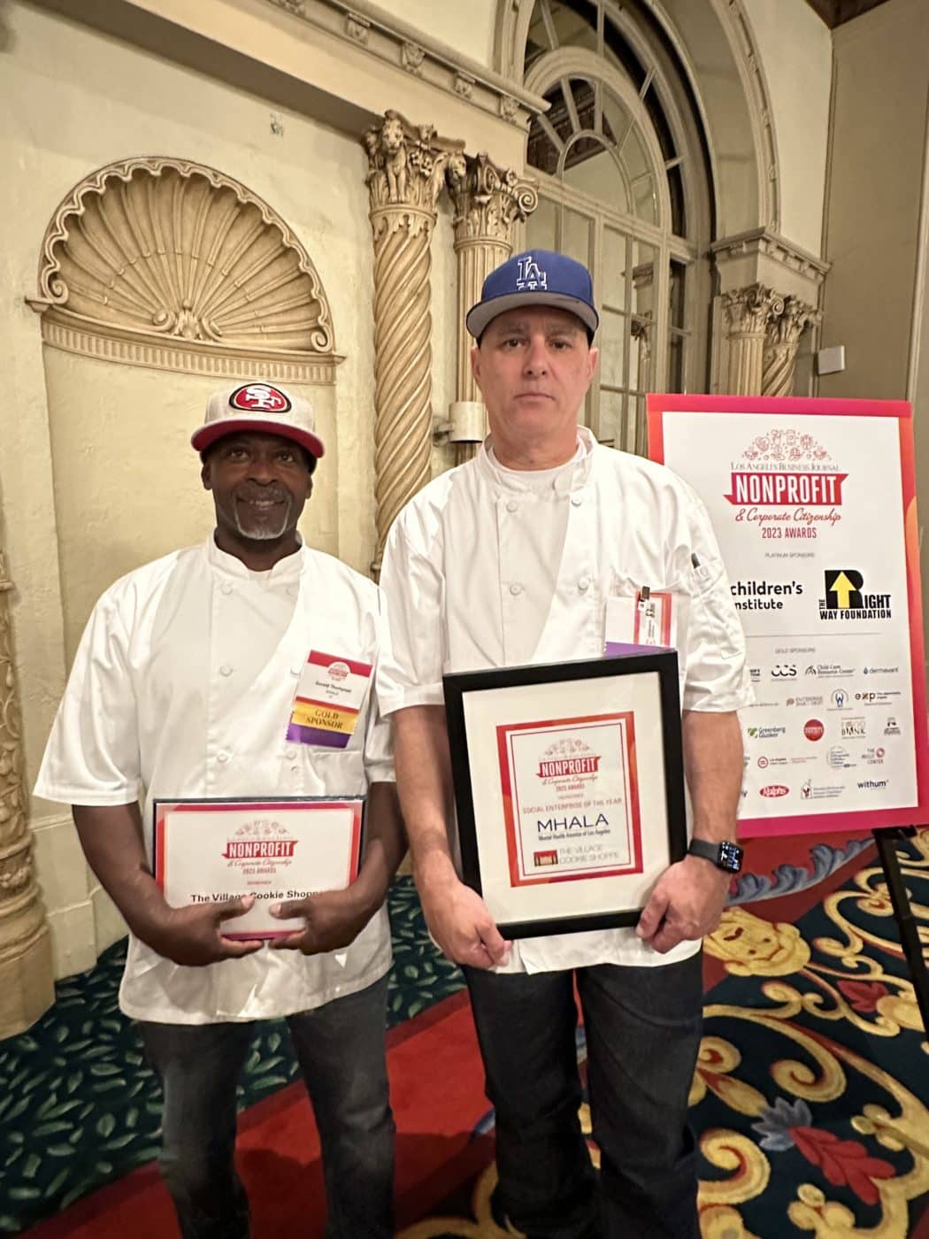 Village Cookie Shoppe chefs holding framed Social Enterprise of the Year award.