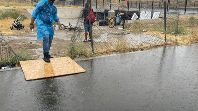MHALA staff walking over flooded waters during Hurricane Hilary