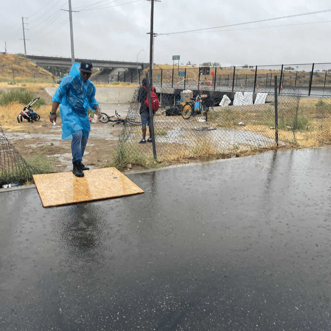 MHALA staff walking over flooded waters during Hurricane Hilary