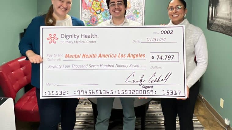 Three MHALA Wellness Center staff members holding a check from Dignity Health to continue HealthLink program.
