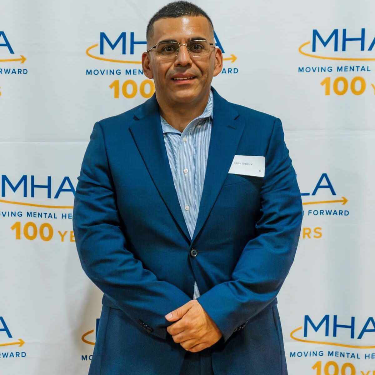 Carlos S MHALA member Carlos S. in front of MHALA backdrop