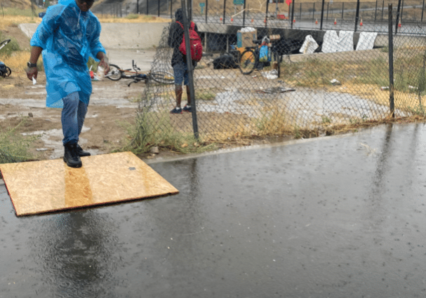 MHALA staff walking over flooded waters during Hurricane Hilary