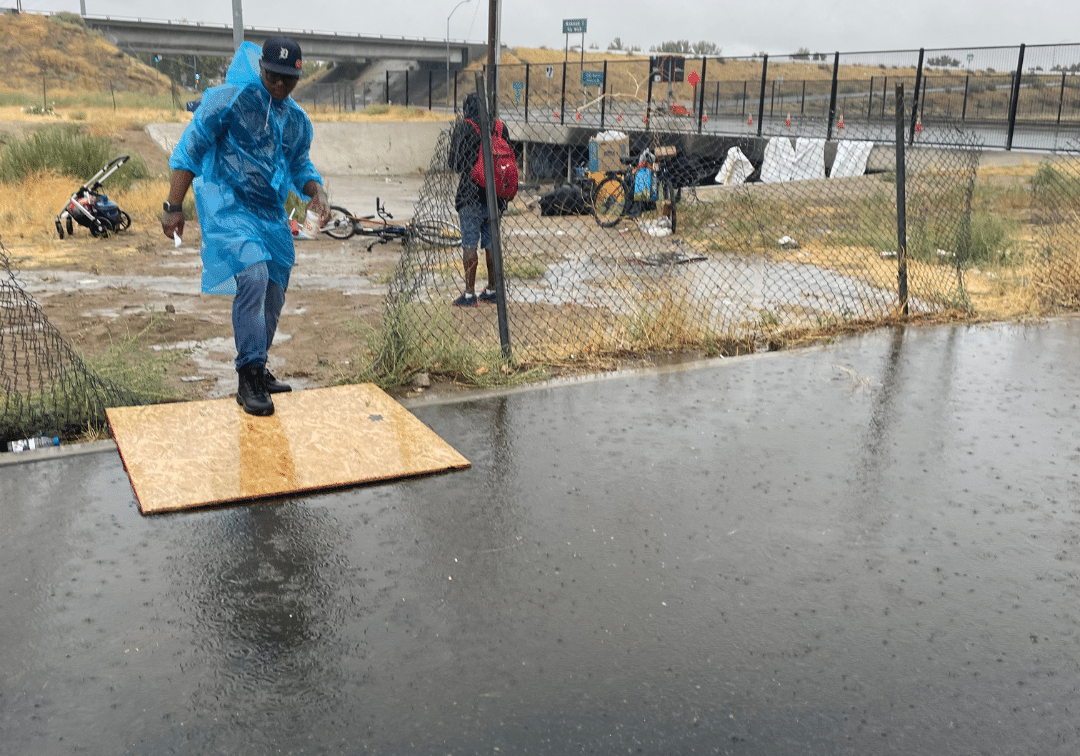 MHALA staff walking over flooded waters during Hurricane Hilary