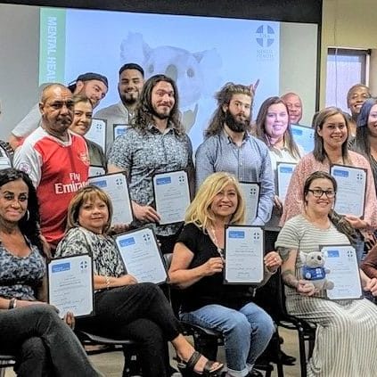 Mental Health First Aid graduates Mental Health First Aid students with their certificates