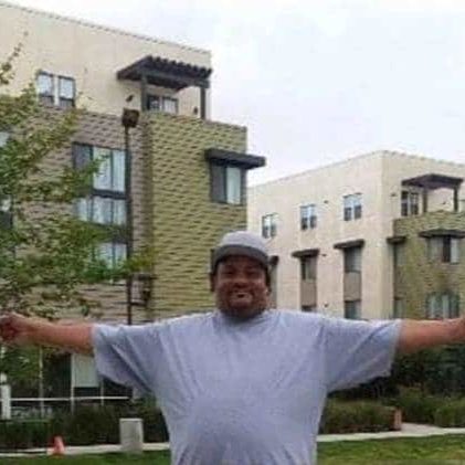 KeithC Copy Man in front of buildings with arms wide open