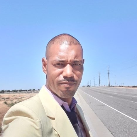 Man looking at the camera with highway behind him
