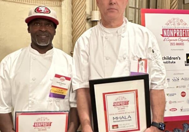Village Cookie Shoppe chefs holding framed Social Enterprise of the Year award.