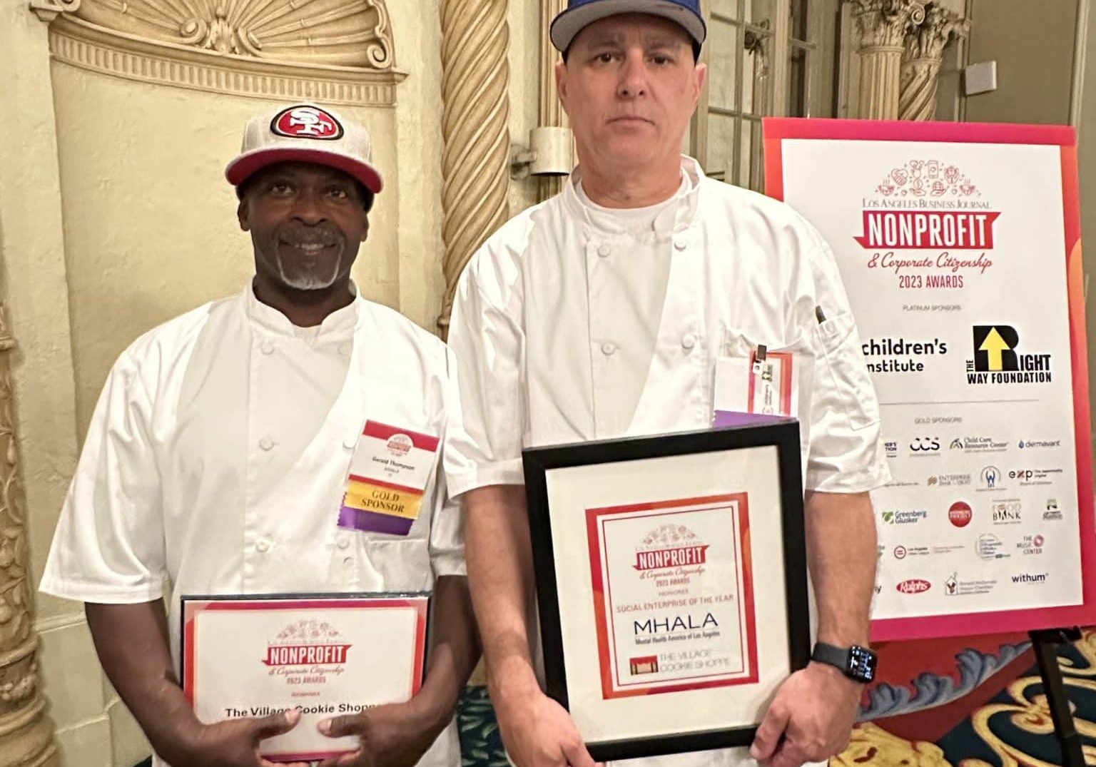 Village Cookie Shoppe chefs holding framed Social Enterprise of the Year award.